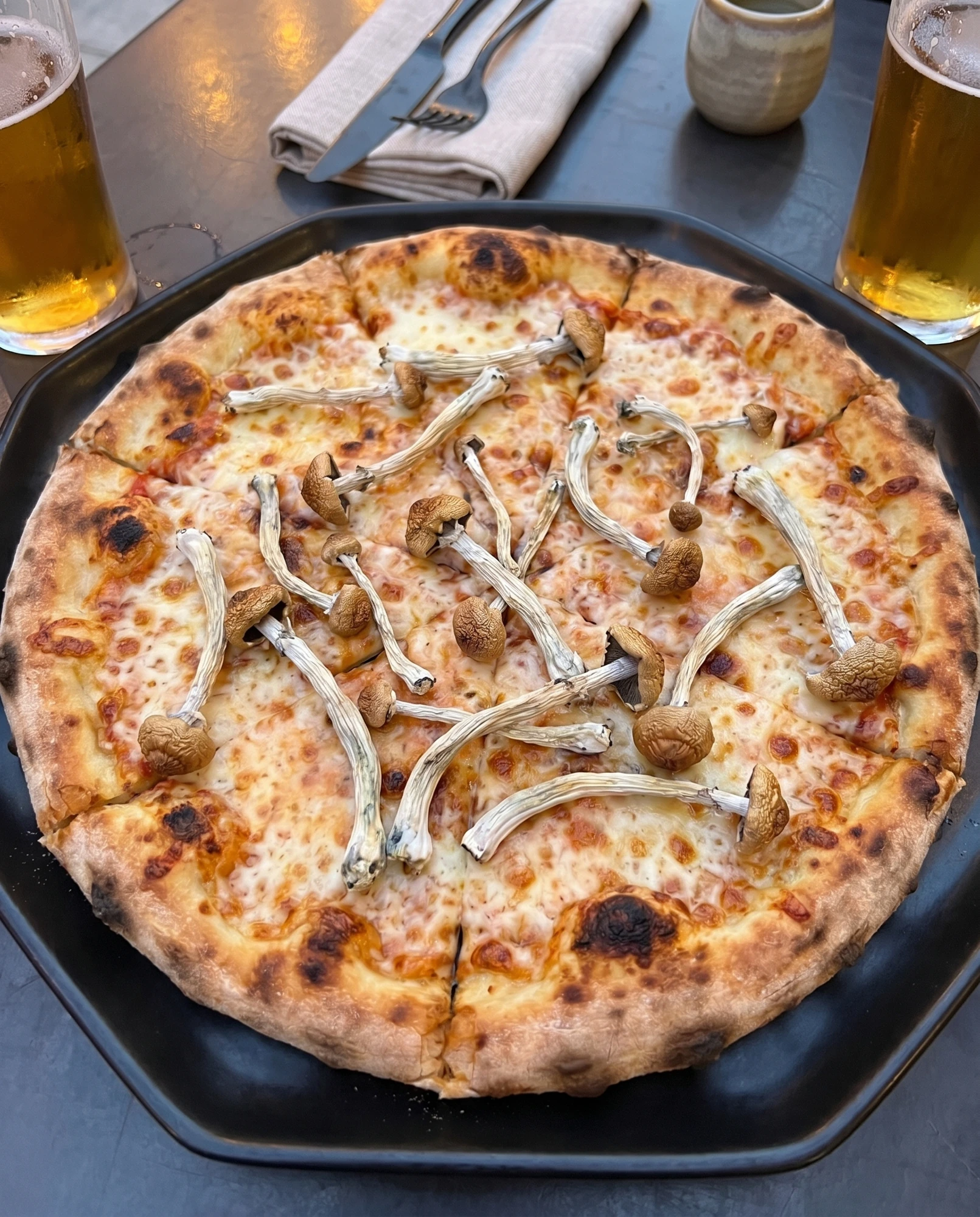 A mushroom-topped pizza on a table.